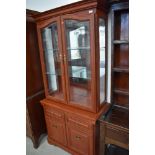 A good quality modern display cabinet with double drawers and cupboard under, illuminating top