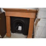 A reproduction cast fire place,and wooden surround