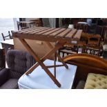 A folding wooden side garden table