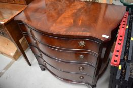 A reproduction mahogany serpentine chesy of four graduated drawers, approx width , 90cm at widest