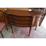 A reproduction Regency sideboard having serpentine front, three central drawers flanked by cupboards