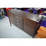 A vintage mahogany effect sideboard, having central set of 4 drawers flanked by cupboard