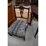 A Victorian mahogany salon armchair with later upholstery, some repair to shield back