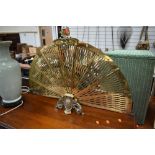 A vintage brass firescreen of fan form , having 9 sections