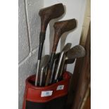 A selection of vintage golf clubs in bag