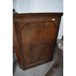 A 19th century oak corner cupboard having panel door, approx width 76cm