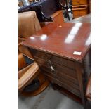 An early 20th Century mahogany music cabinet, having 5 drop flap drawers and undershelf