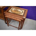A vintage tile top nest of three tables
