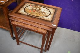 A vintage tile top nest of three tables