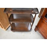 A dark stained Ercol tea trolley, on large shepherds casters