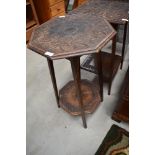 An Arts & Crafts plant stand/occasional table, octagonal form, heavily carved holly and berry