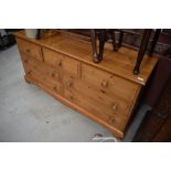 A modern pine low sideboard/chest of three over two by two drawers, would make a good widescreen