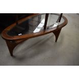 A vintage stained frame and glass coffee table of teardrop design, width approx. 132cm