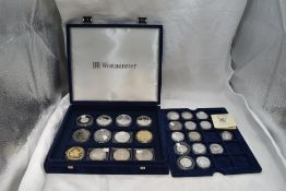 A collection of 26 Silver Commemorative coins of various size in fitted case