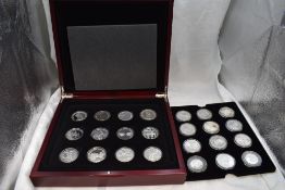 A collection of 24 Silver Commemorative Royalty crown sized coins in fitted case