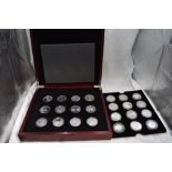 A collection of 24 Silver Commemorative Royalty crown sized coins in fitted case