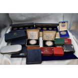 A collection of World Silver Coins & Medallions in cases