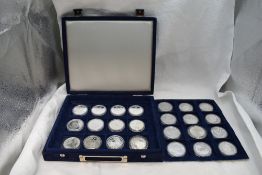A collection of 24 silver crown sized coins including Australian Koala's, Commemoratives etc in