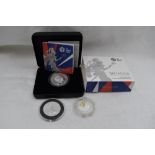 A 2017 2 Pound 1oz Silver Britannia Coin in case, a 50 Pound 2015 Silver Britannia Coin and a 5