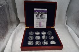 A collection of 12 Commonwealth 80th Birthday Silver crown sized coins, in fitted case