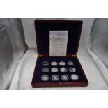 A collection of 12 Diamond Wedding Anniversary Silver Commonwealth crown sized coins, in fitted case