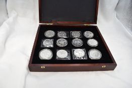 A collection of 24 Canadian 1 Dollar to 10 Dollar silver coins in wood case