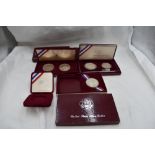Three boxed sets of USA Olympic Silver Coins, 1984 Olympics x2 and 1992 Olympics, 5 coins in total