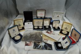 A collection of GB Silver Coins in cases and on cards, 5p, 10p, £1, Crowns, £5 and £20