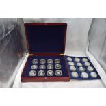 A collection of 24 Commonwealth Royalty crown sized silver coins, in fitted case