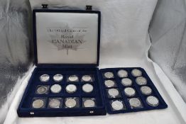 A collection of 24 Silver Canadian coins including 1oz, in fitted case