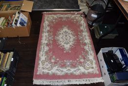 A Traditional style hearth rug having floral pattern and fringed edging
