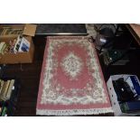 A Traditional style hearth rug having floral pattern and fringed edging