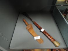 A hand carved antique knitting stick of traditional design and similar shoe horn