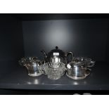 A mid century insulated tea pot, jug and sugar basin, having cream ceramic bodies with chrome