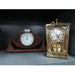 An early 20th century mantle clock being Swiss made signed Burnem having mahogany case also