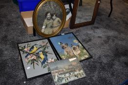 A selection of embroideries and an oval gilt framed mirror