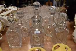 Six vintage glass decanters, various shapes and styles.