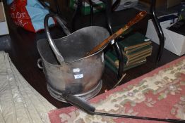 A stainless coal bucket/helmet,a shovel and a long shoe horn.