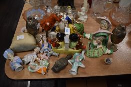 A mixed lot of Staffordshire style book ends, doll bodies, cruet set depicting two babies sitting in