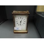 A brass cased French carriage clock having enamel face plate