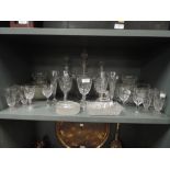A selection of clear cut and crystal glass wares including decanters and champagne flutes