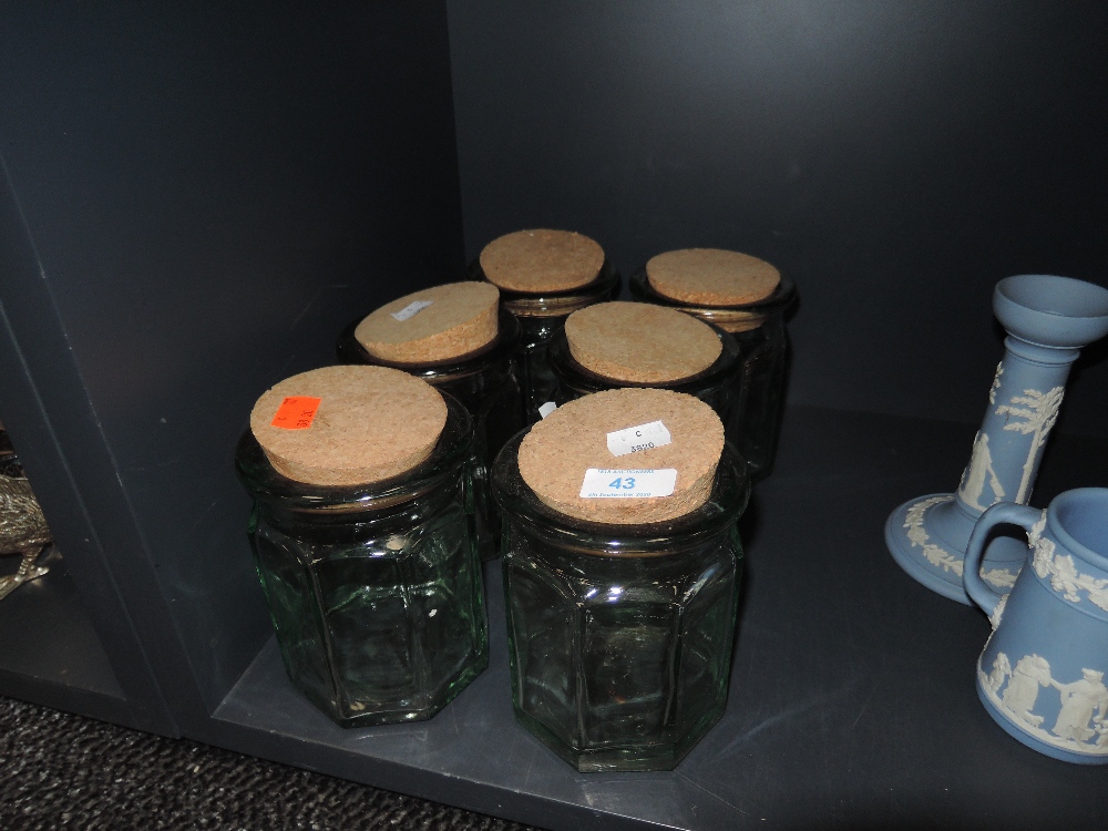 A selection of refillable green glass jars with cork libs