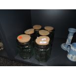 A selection of refillable green glass jars with cork libs