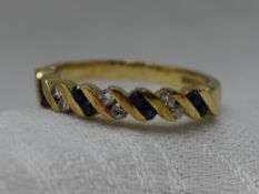 A lady's half eternity ring having channel set diamond and sapphires in a diagonal design on a 9ct