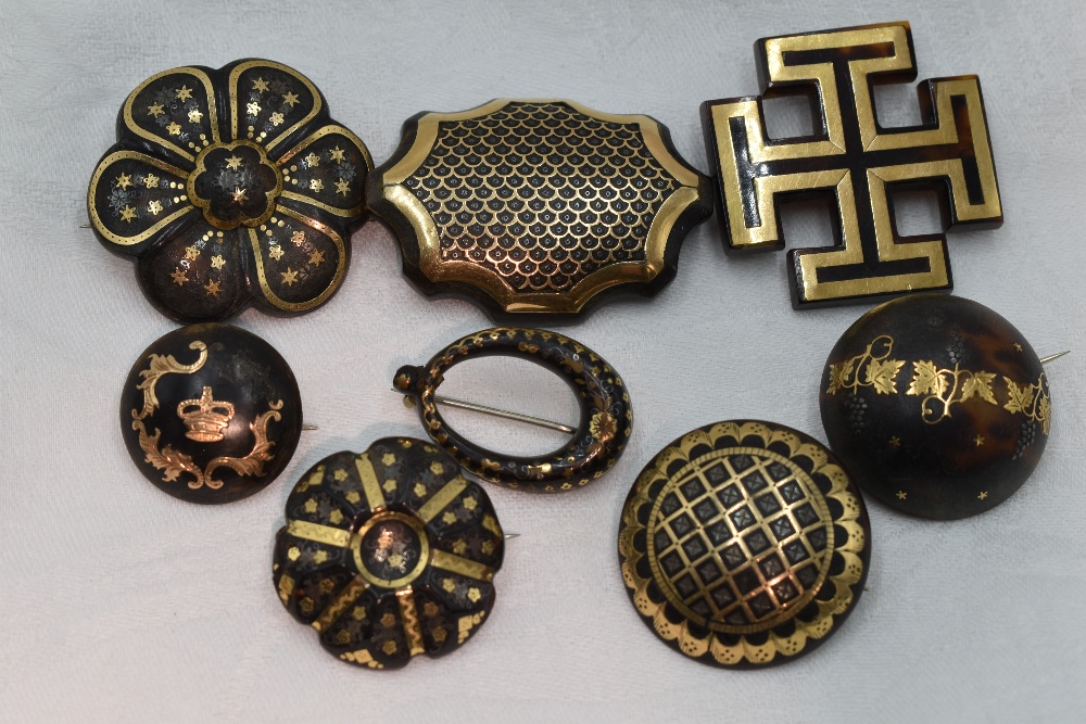 Eight Victorian tortoise shell brooches of various forms, all having pique decoration