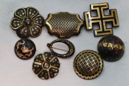 Eight Victorian tortoise shell brooches of various forms, all having pique decoration
