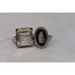 A lady's dress ring having an oversized paste stone to four claw collared mount to white metal loop,