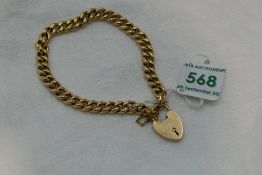 A 9ct gold curb chain bracelet having a padlock clasp