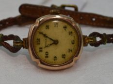 A lady's vintage 9ct rose gold Rolex wrist watch having an Arabic numeral and gilt dot dial in