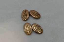 A pair of 9ct gold cufflinks of oval form having engraved floral decoration and chain connectors